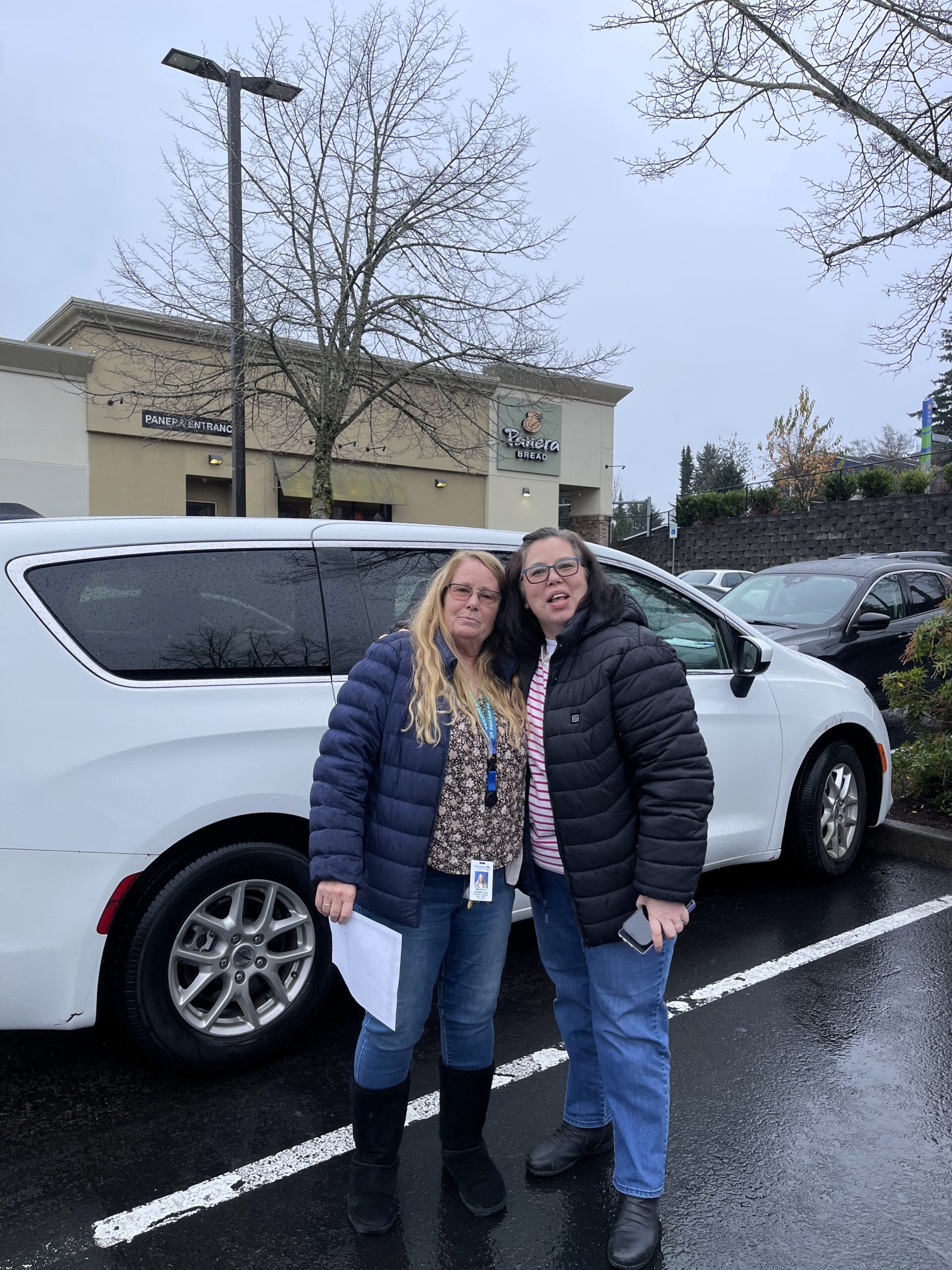 Two Cascadians posing in front of a white van during meal delivery