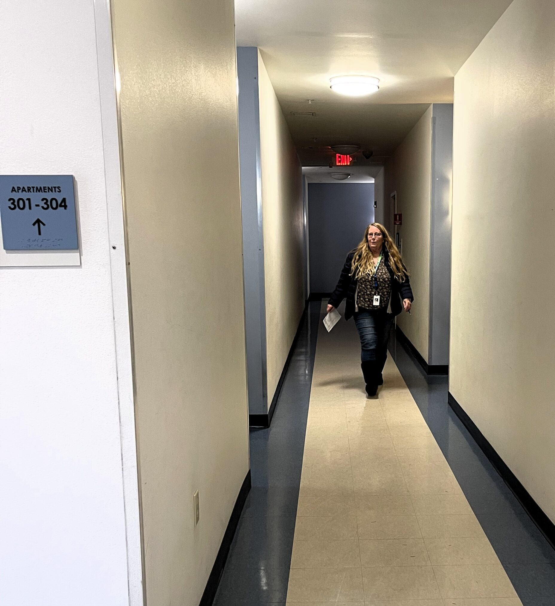 Marianne Oniell Tutor walking down the hallway of an apartment community during meal delivery